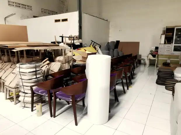 Finished chairs wrapped and stacked ready for loading