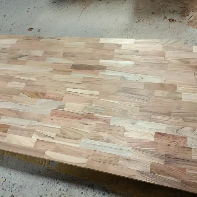 Finger-jointed teak panel laid up for a table top
