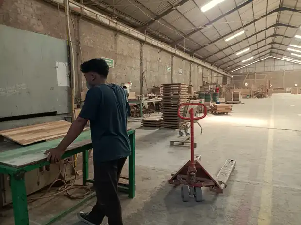 Machinist feeding a panel through the wide belt